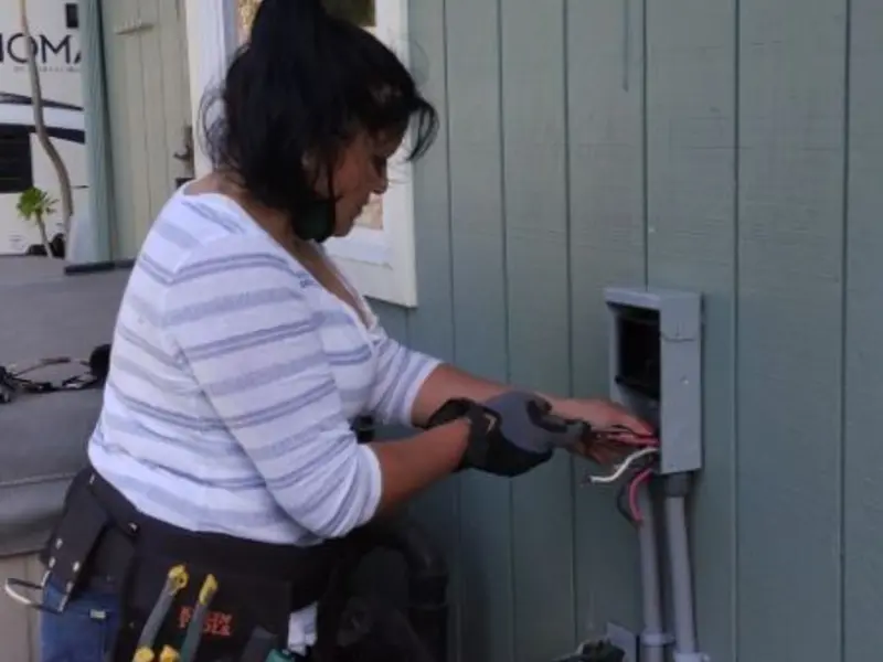 Licensed electrician wiring an exterior subpanel in Melrose